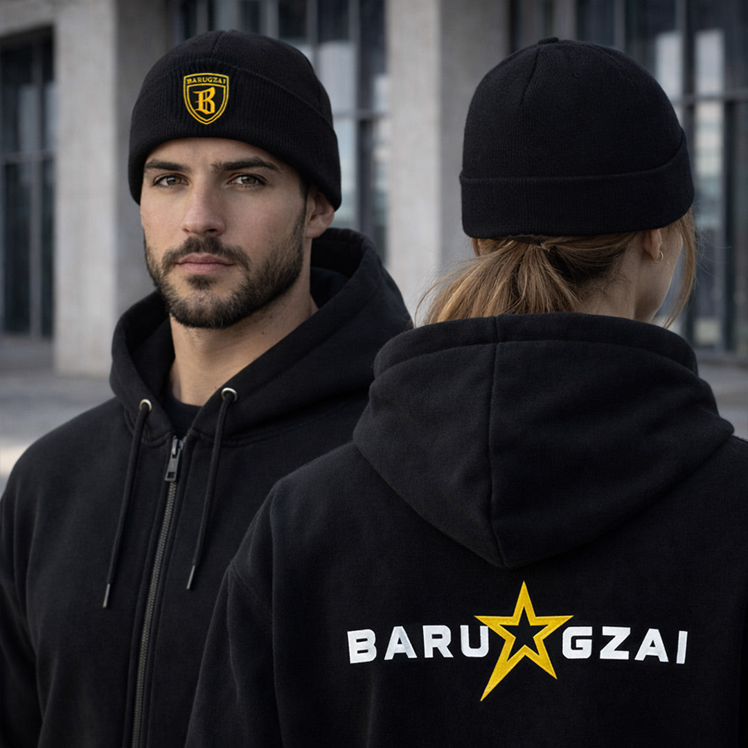 Female and male version of the cuffed beanie in a life style shot with the barugzai star lettering on the rear of the hoodie.