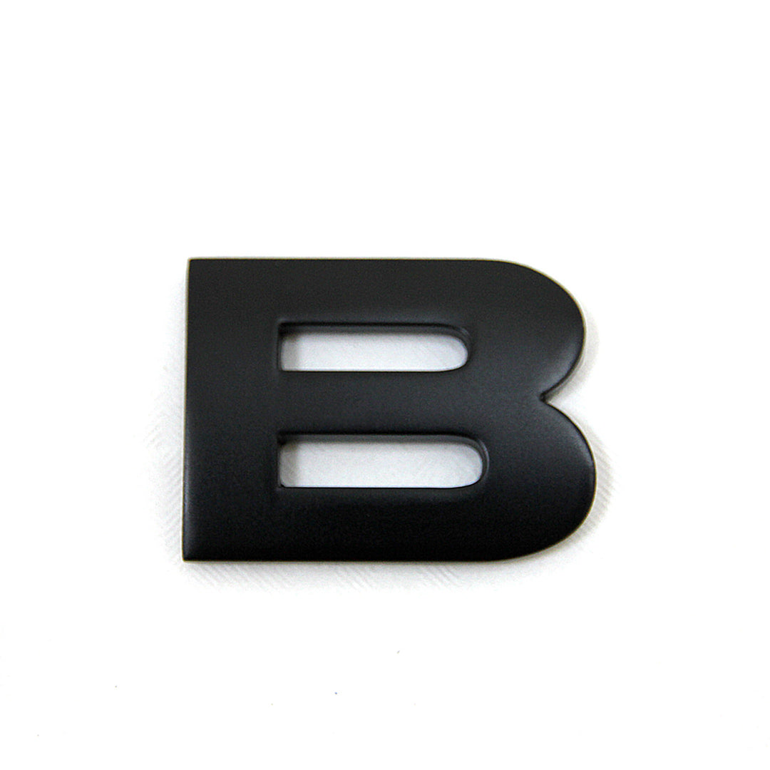 Matte Black letter 'B' lettering on a white background