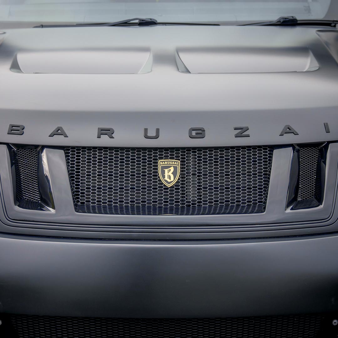Detail view of the Satin Grey Range Rover front grille and Barugzai lettering on the bonnet, showcasing premium design cues.