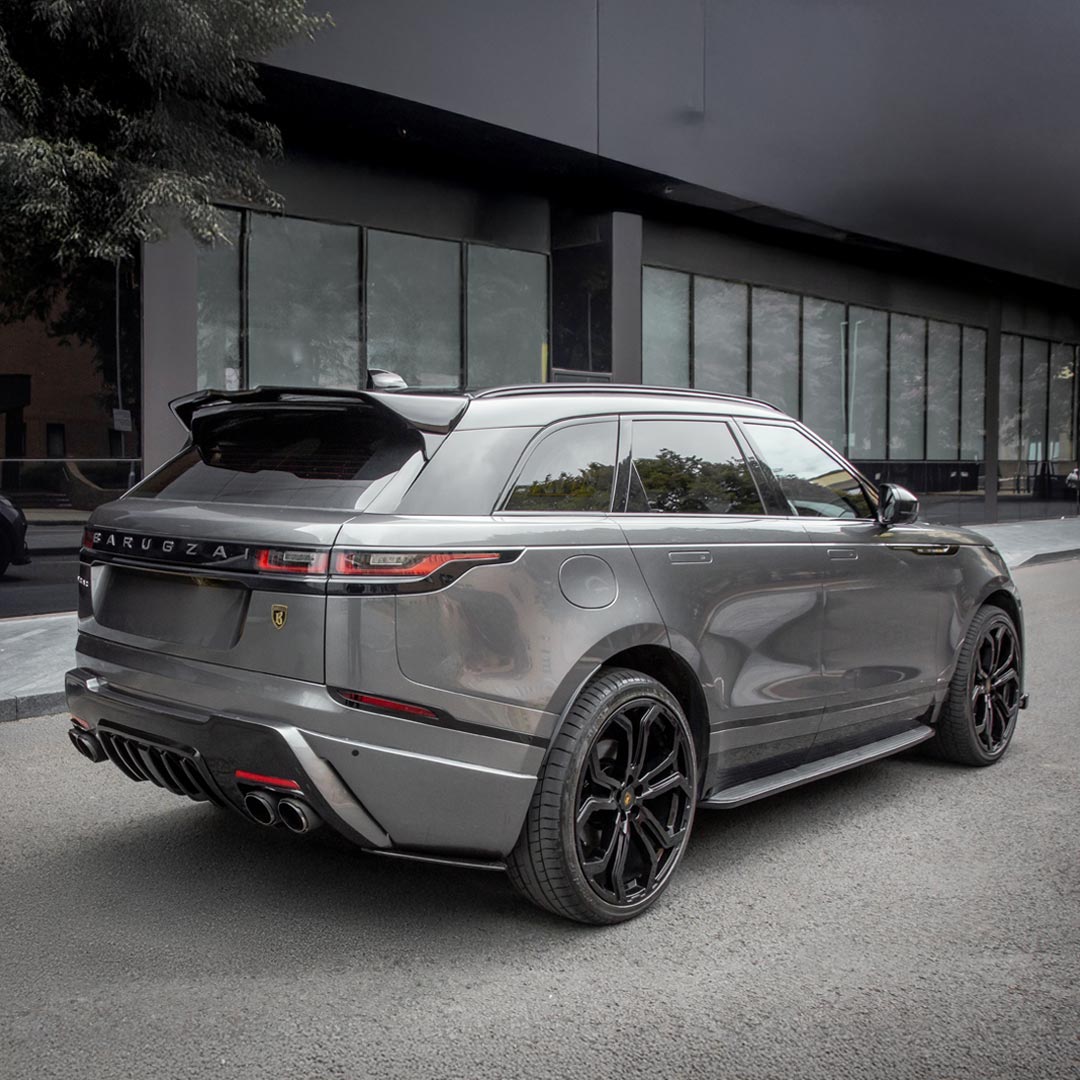 Rear quarter hero view of a modified Grey Range Rover Velar highlighting rear apron, spoiler, and Barugzai branding details.
