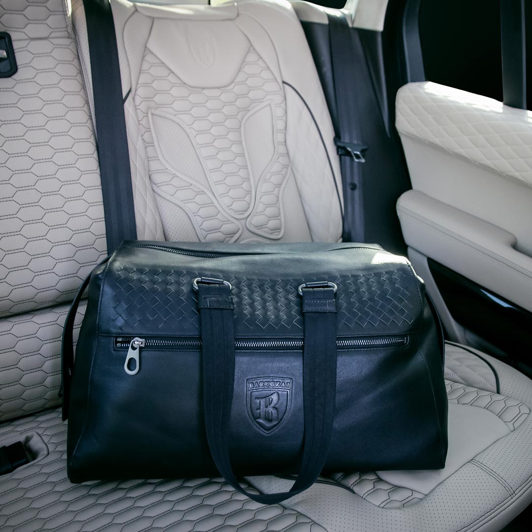 Barugzai leather holdall lifestyle shot inside luxury vehicle interior
