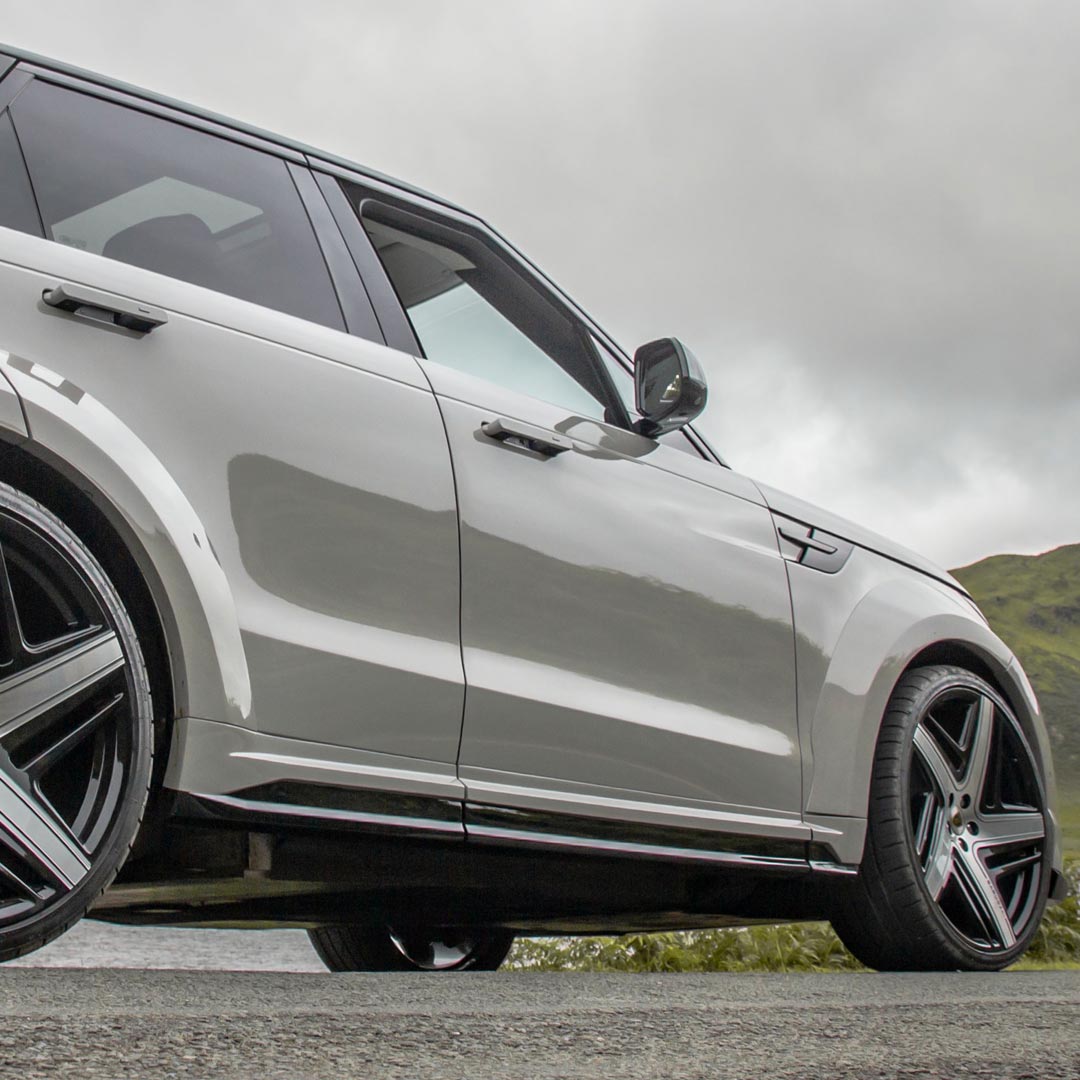 Nardo Grey Detail view of Barugzai Raptor Body Kit side skirts and extended wheel arches on Range Rover Sport L461