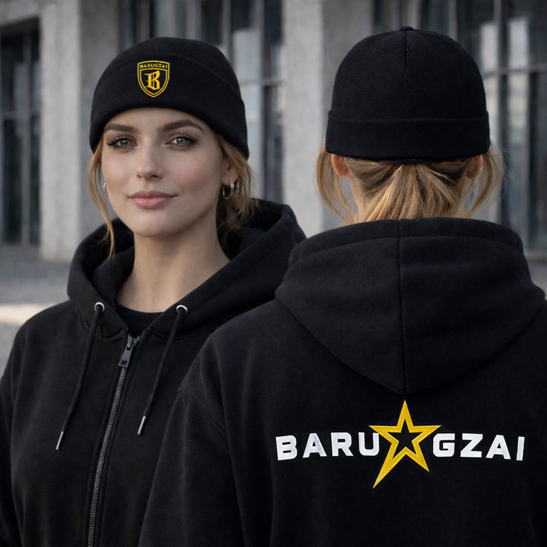 Female Cuffed Beanie on a female model on a lifestyle shot with an urban background. The rear view on the side has the hoodie on and the rear of the beanie. 