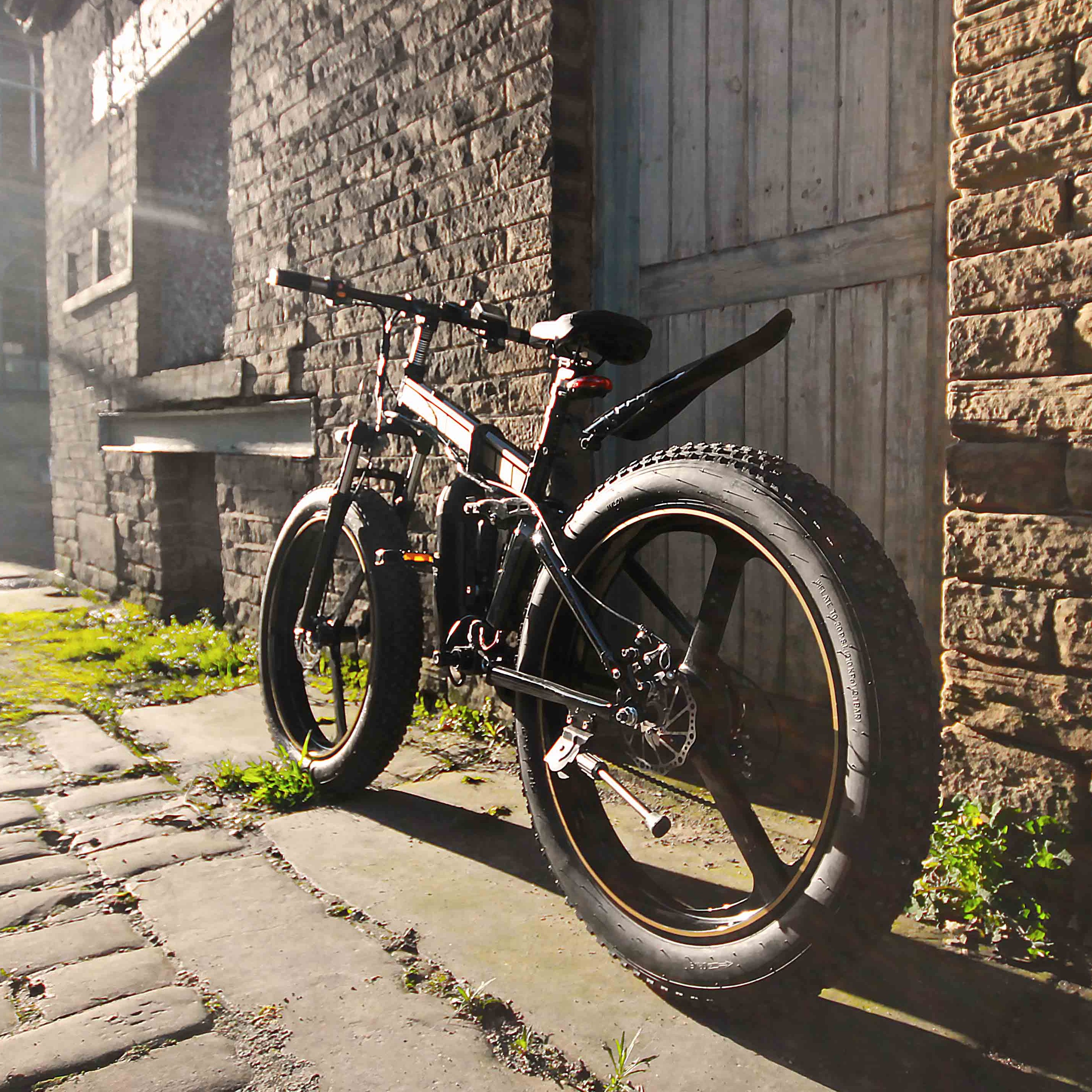 Bicycle leaning against a brick wall on a sunlit street