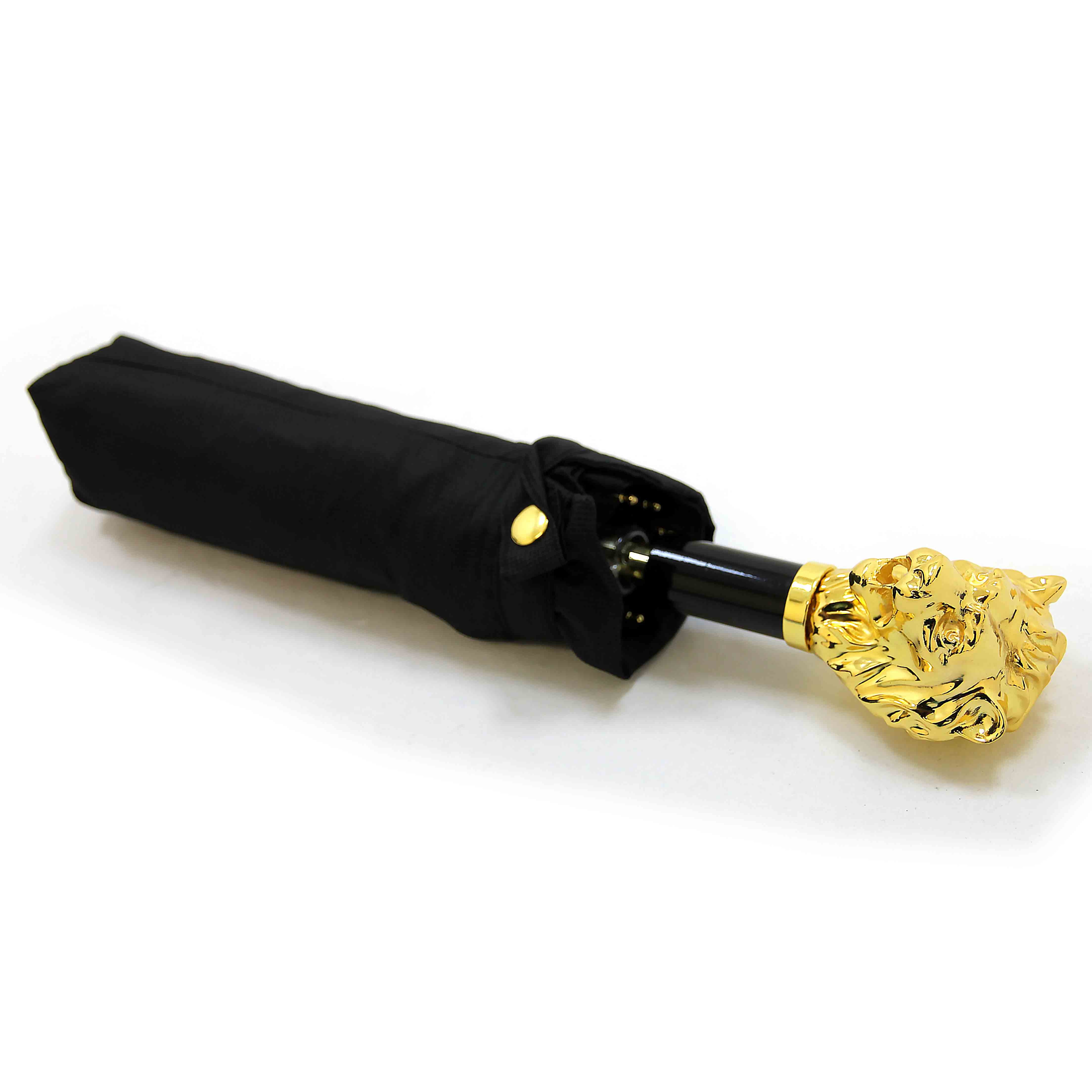 Black umbrella with gold lion handle on a white background.