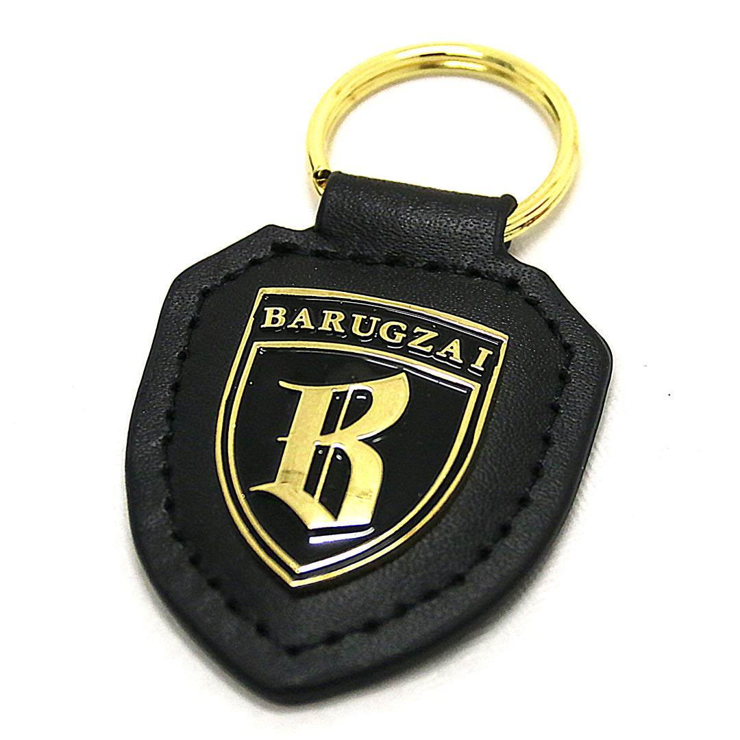 Black and golden Barugzai Key chain MK I with a white background. 