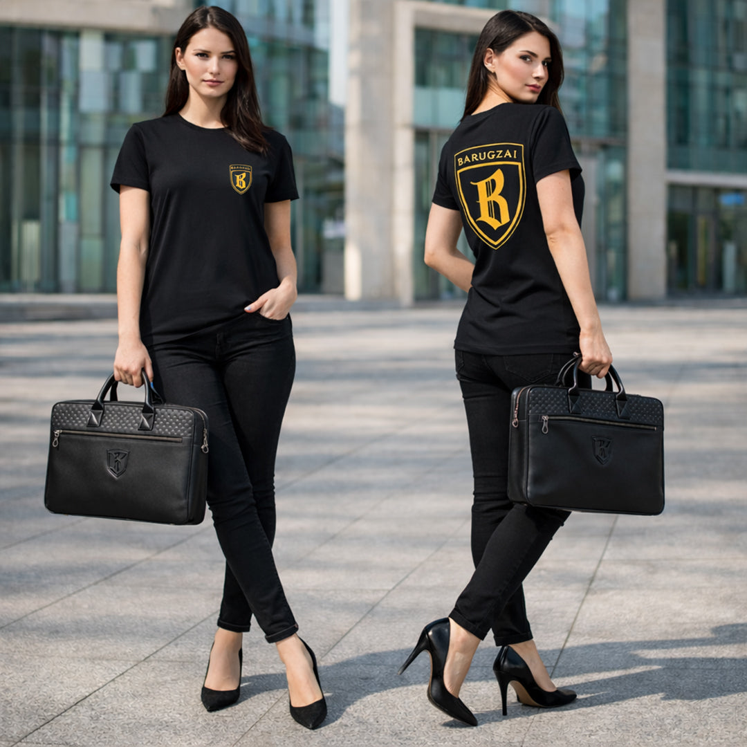 Two women wearing black barugzai t-shirts with logos, holding black leather laptop bag briefcases in an urban setting.