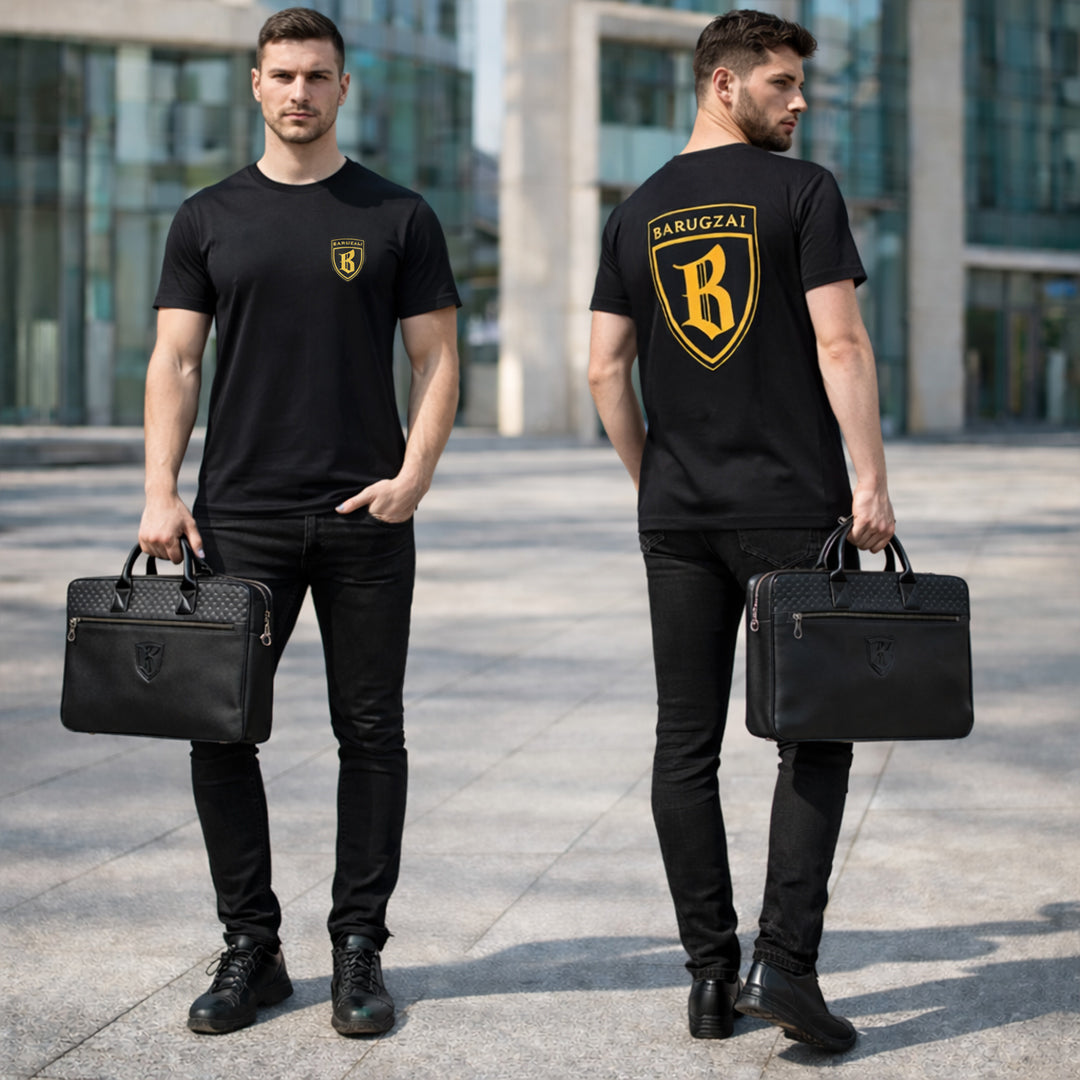 Two men wearing black barugzai shield t-shirts with a logo, holding black leather laptop bags in an urban setting.