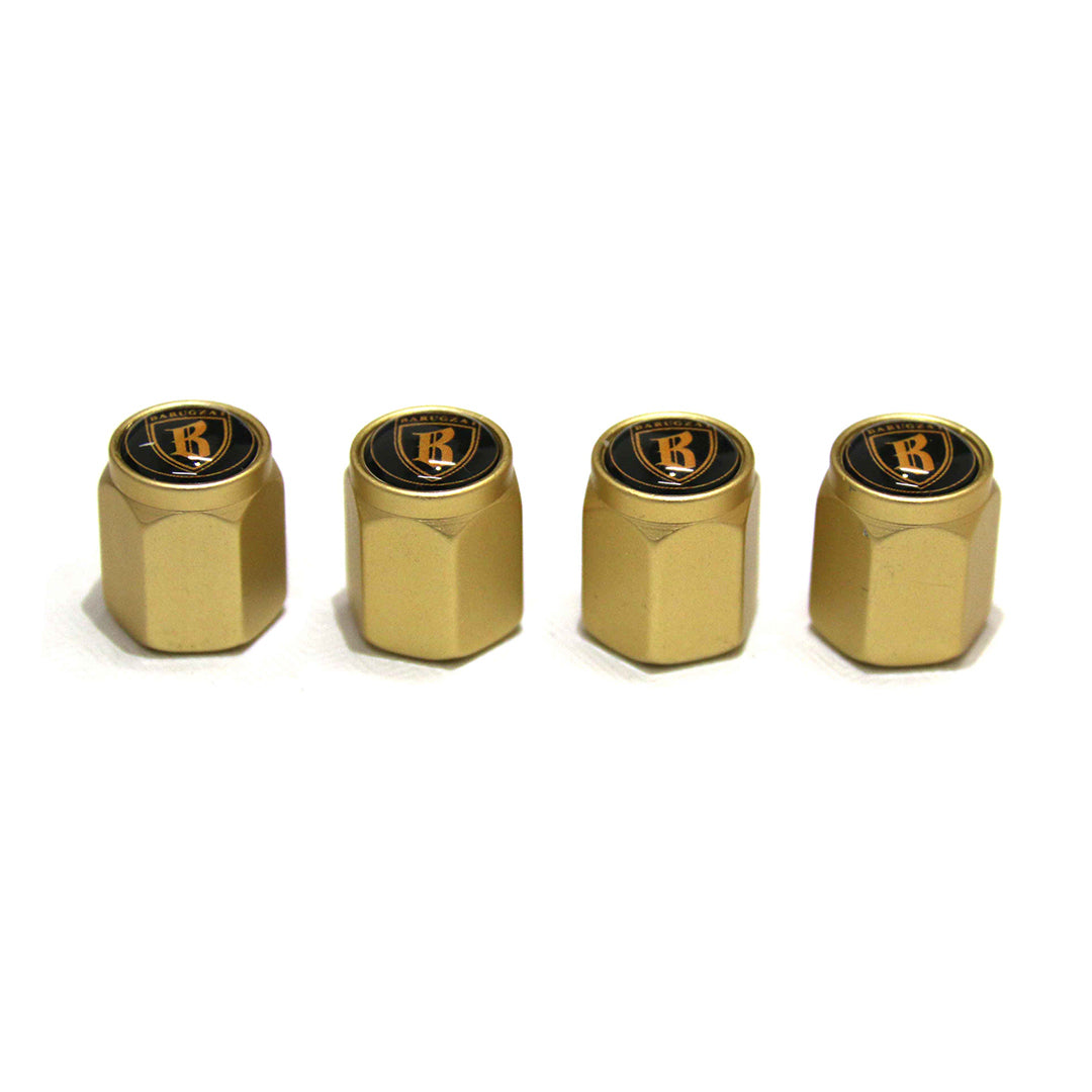 Four gold valve stem caps with a black logo on a white background