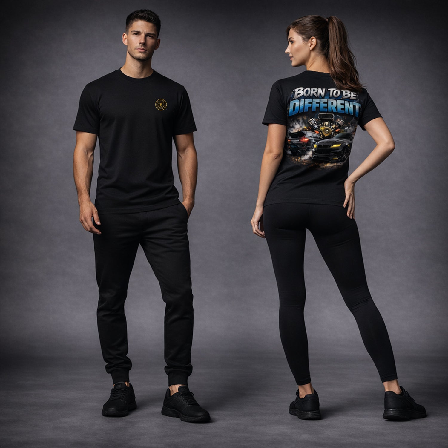 Man and woman wearing black t-shirts with graphic designs on a gray background.