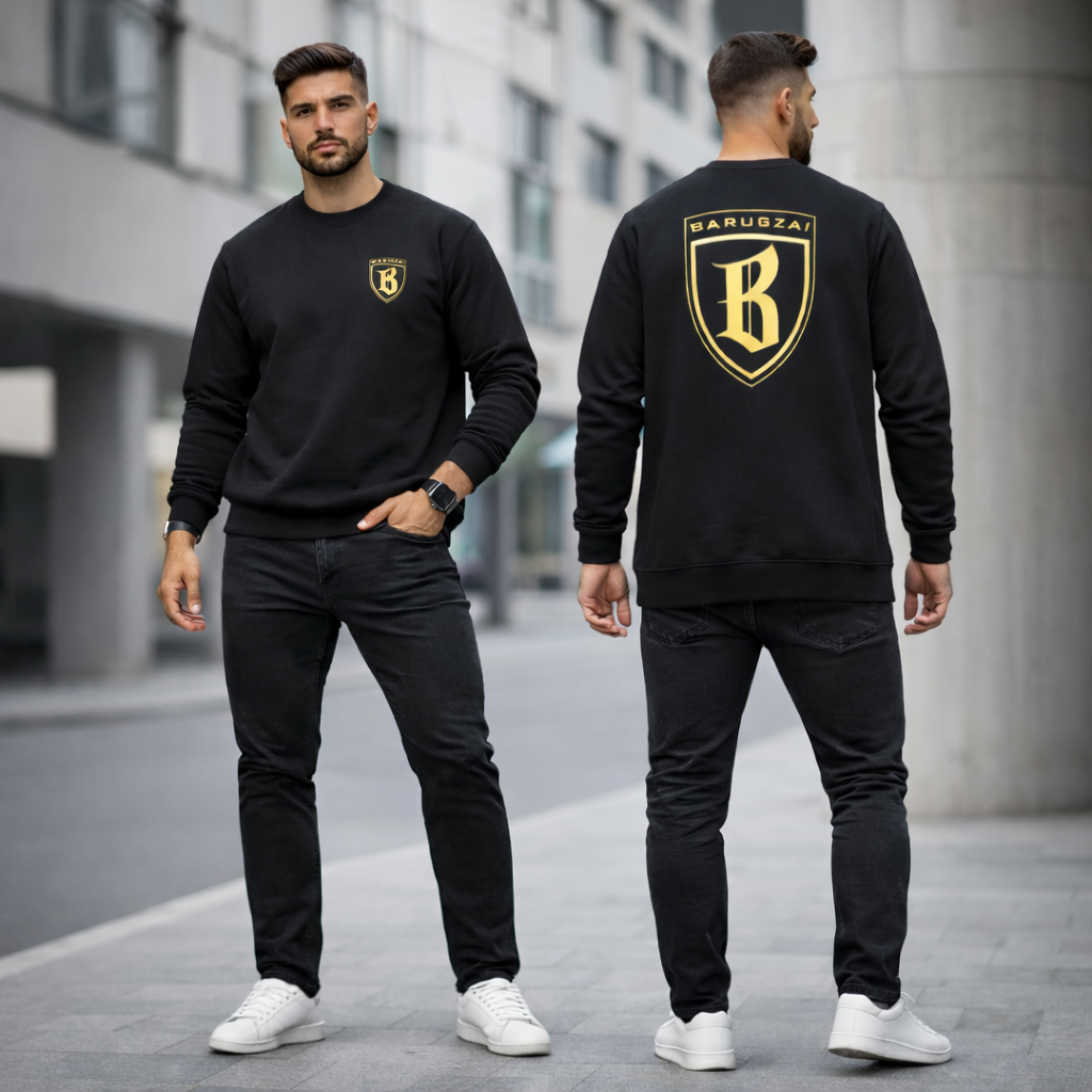 Man wearing a black sweatshirt with a barugzai gold logo on the front and back, standing on a street.