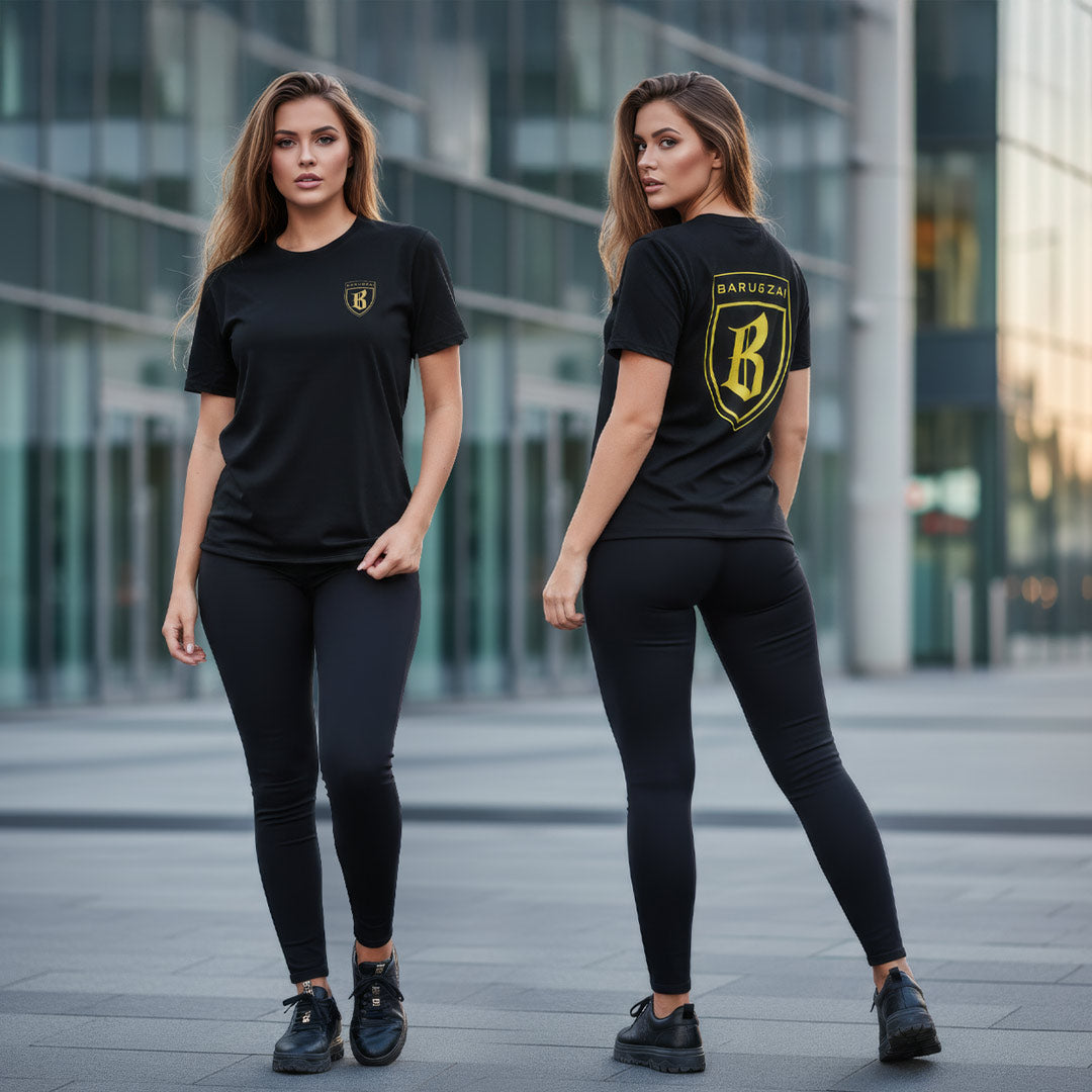 Two women wearing black and gold barugzai  t-shirts with a logo in an urban setting