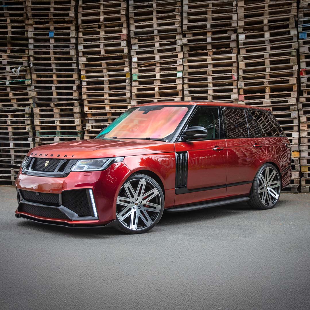 Wide front quarter angle of the Red Range Rover Vogue with Barugzai Bison kit, showing full stance and road presence.