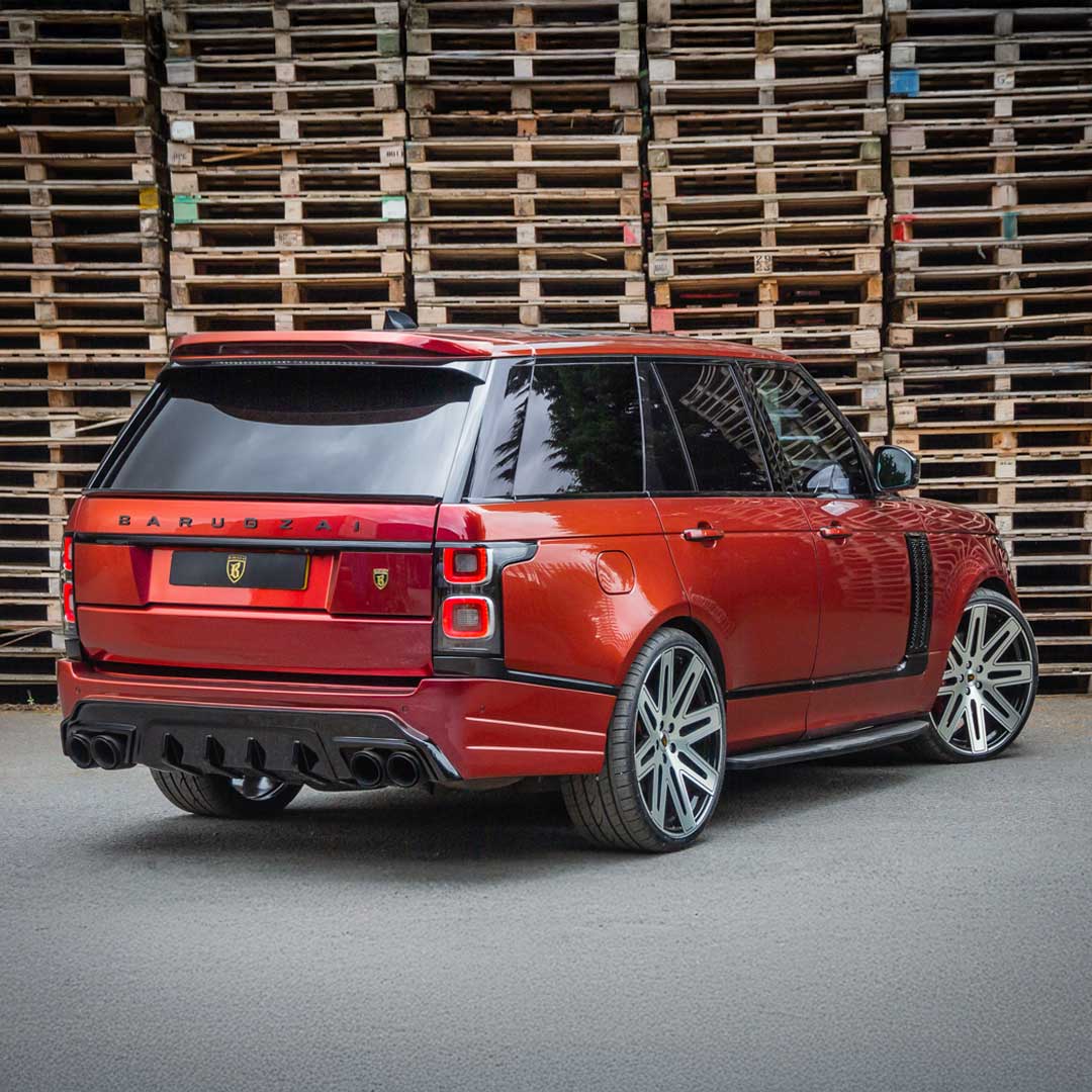 Rear quarter hero shot of the Red Range Rover Vogue, emphasising Bison kit width and rear design.