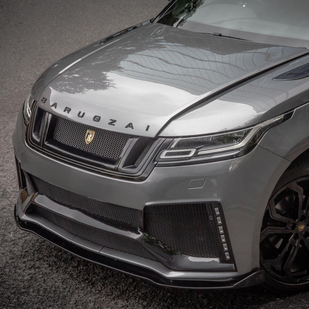 Detail of Grey Range Rover front grille and Barugzai lettering showcasing bespoke finish and luxury refinement.