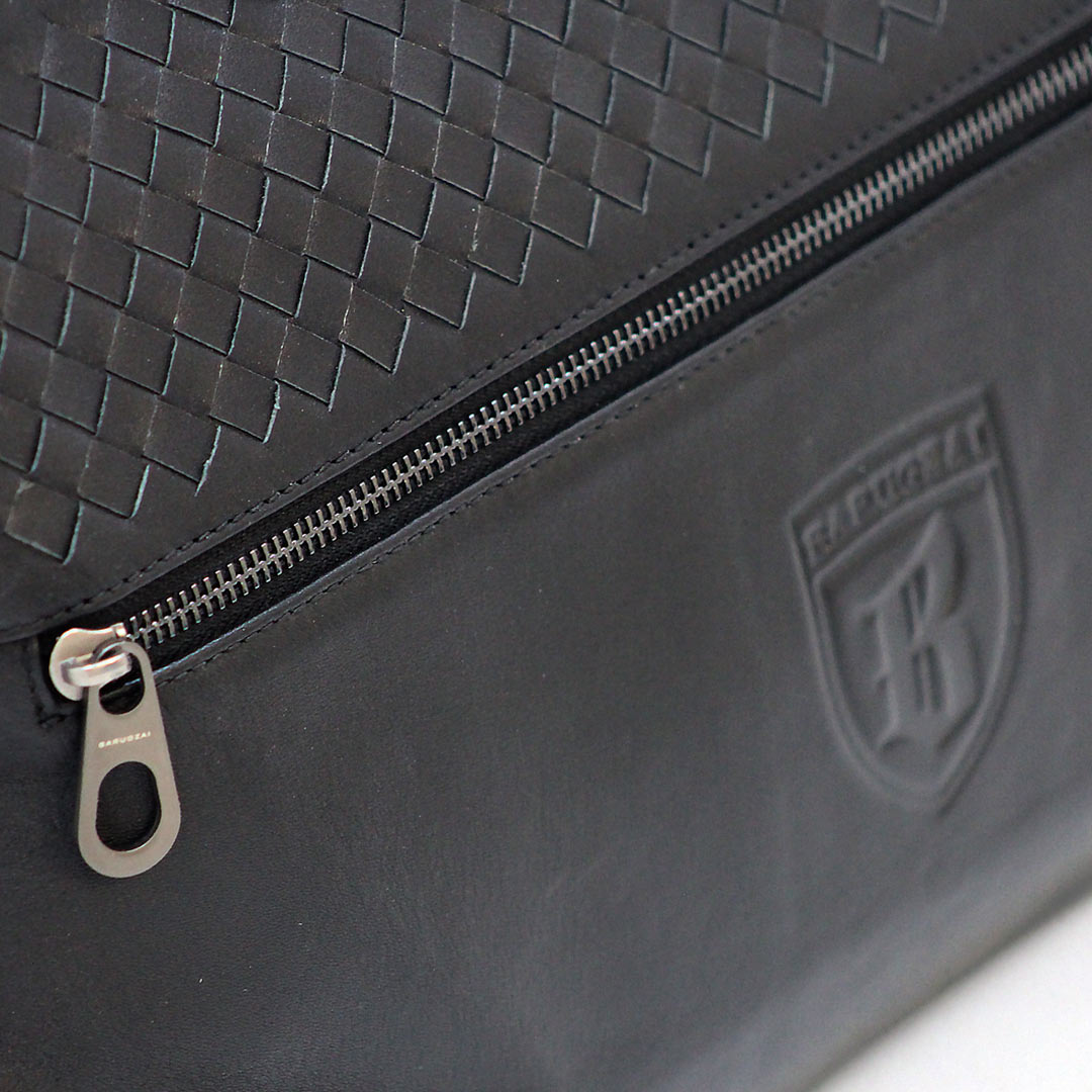 Close-up of Barugzai leather holdall woven leather panel and zip detail