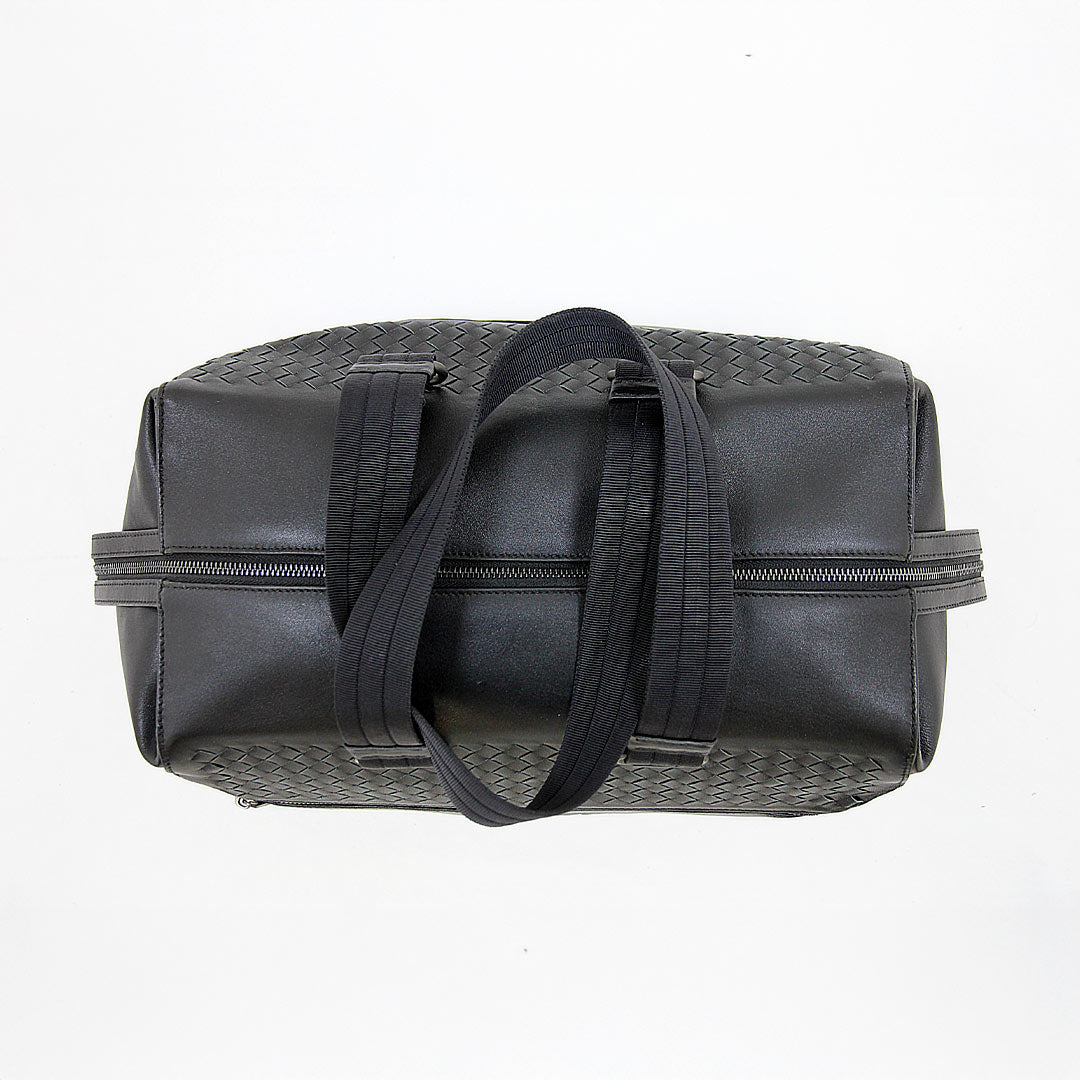 Top view of Barugzai leather holdall showing woven leather detailing and carry handles