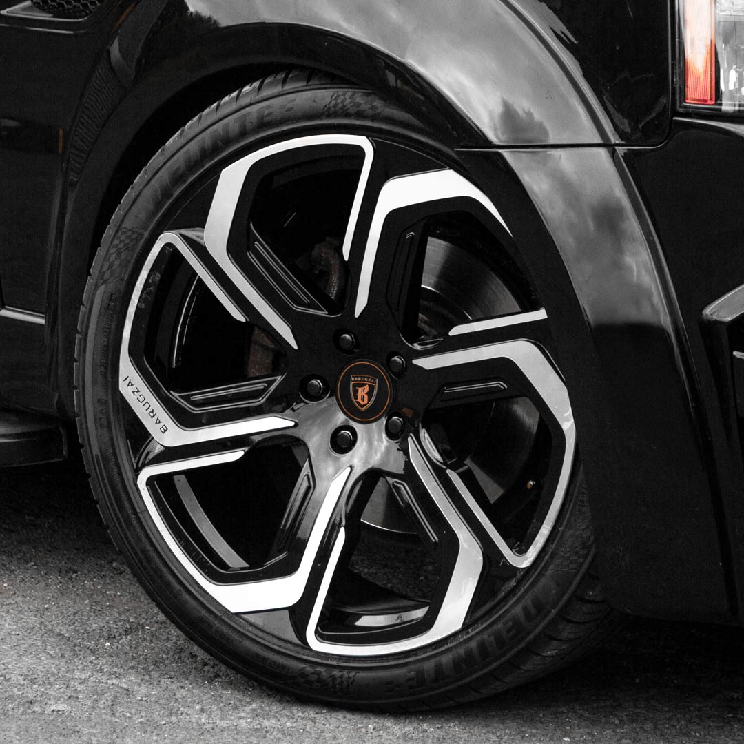 Side angle view of Barugzai Sabre 22 inch wheel showing curved scimitar spoke design